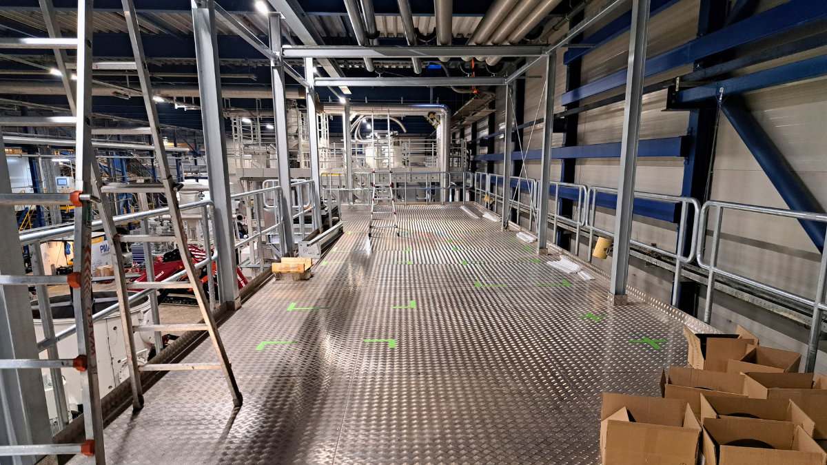 Het nieuw gebouwde bordes in de fabriek van CIrrec biedt plaats aan skids met warmtepompen, leidingen en pompen.